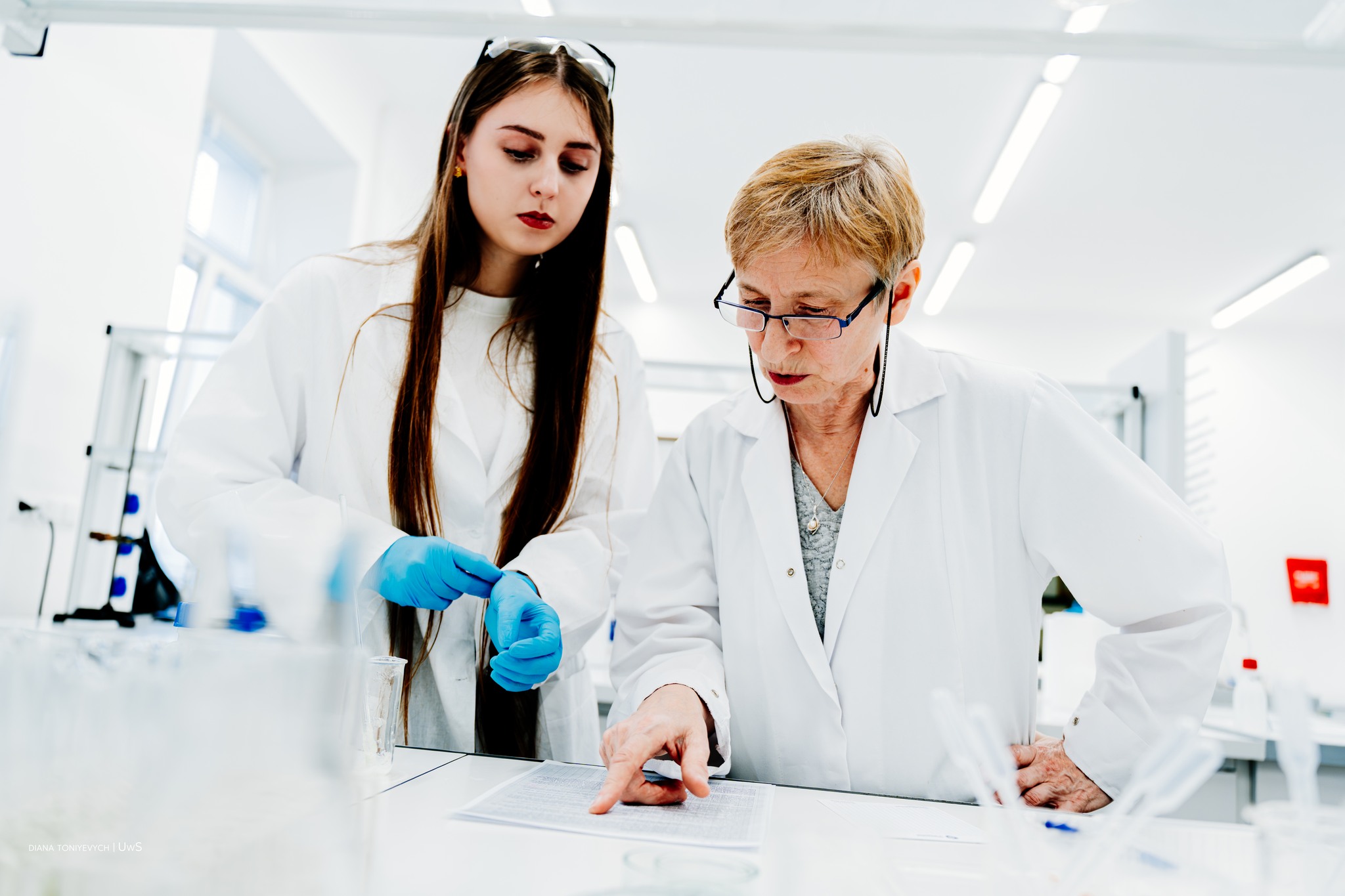 Dwoje chemików w laboratorium z uwagą czytają dokumentację