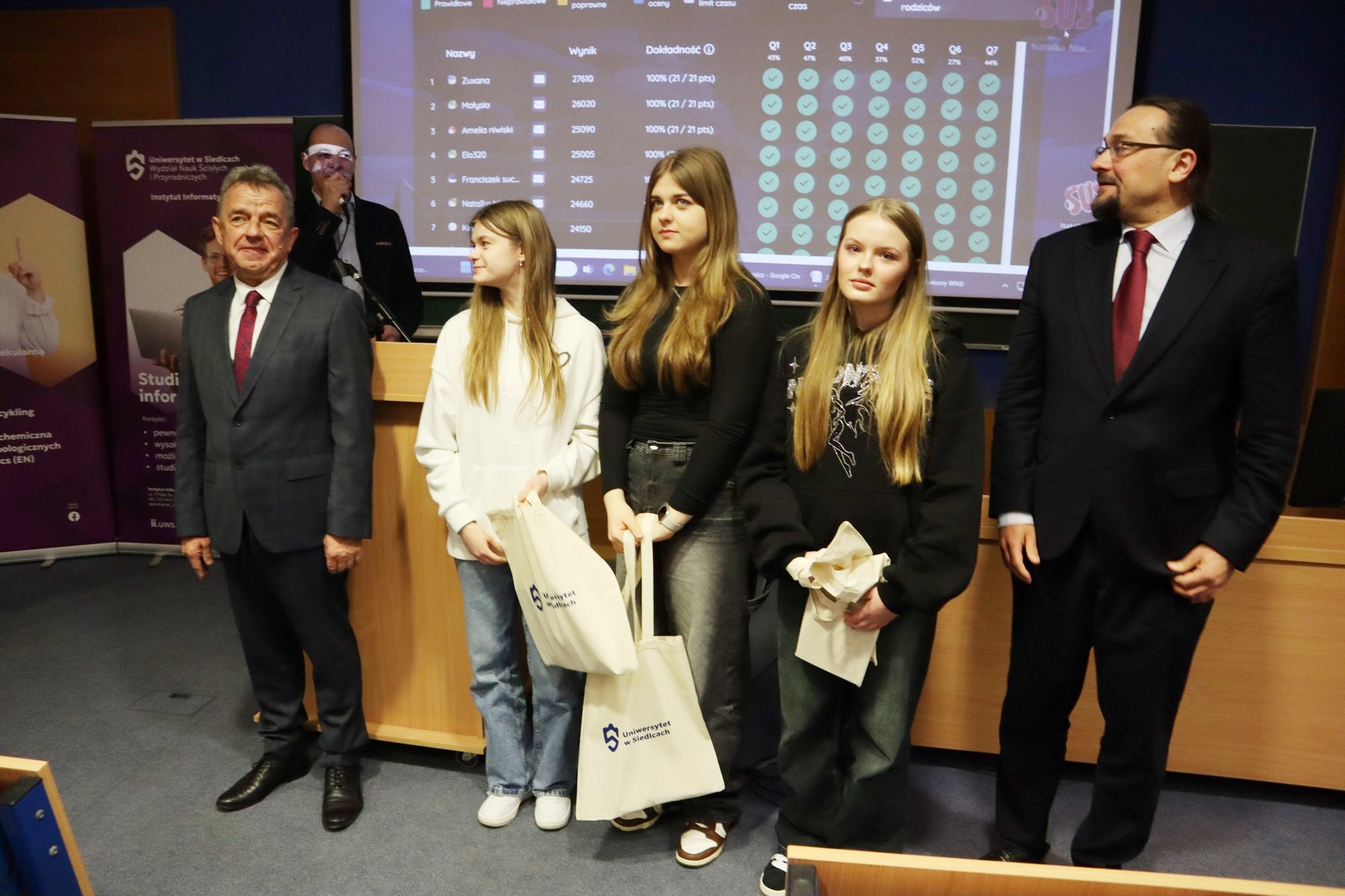 Dziekan wydziału C. Sempruch w towarzystwie dyrektora A, Niewiadomskiego wręcza nagrody trzem finalistkom quizu